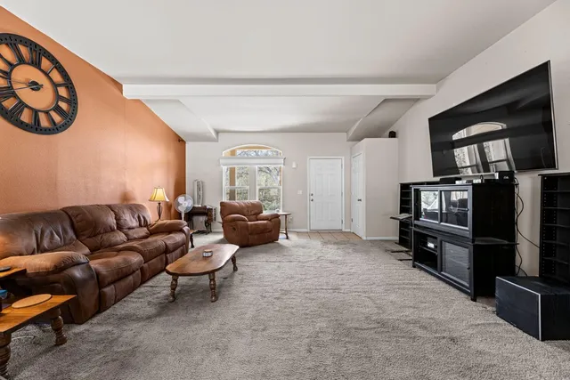 a living room with furniture wooden floor and a flat screen tv