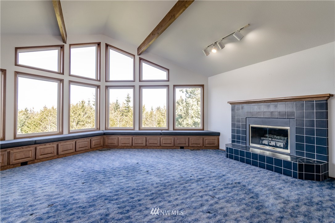 449 Guy Kelly Road Port Angeles, WA 98362 - Photo 11 of 40 wooden floor fireplace and windows in an empty room