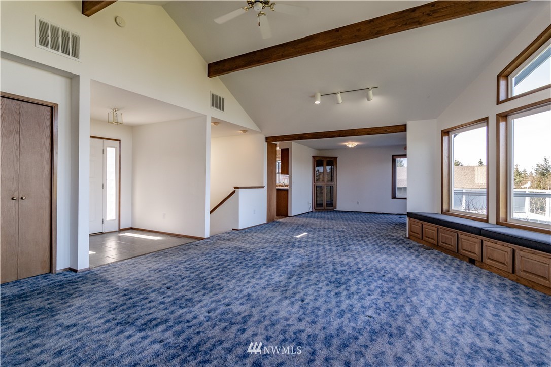 449 Guy Kelly Road Port Angeles, WA 98362 - Photo 13 of 40 a view of empty room with a fireplace and windows