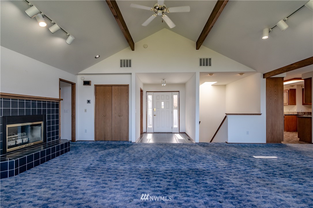 449 Guy Kelly Road Port Angeles, WA 98362 - Photo 14 of 40 a view of empty room with wooden floor and fireplace