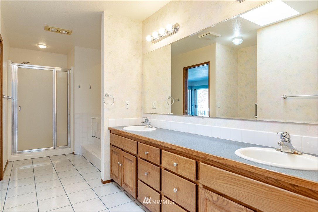 449 Guy Kelly Road Port Angeles, WA 98362 - Photo 21 of 40 a bathroom with a sink and a mirror