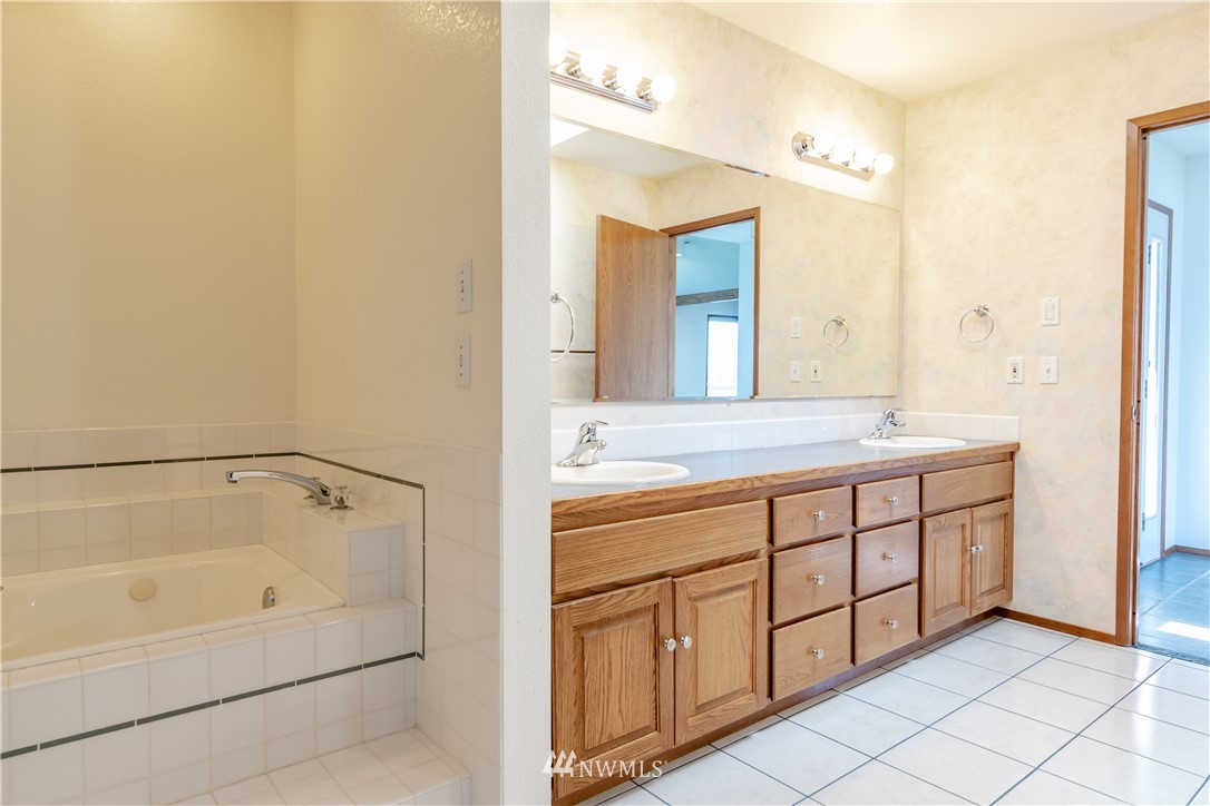 449 Guy Kelly Road Port Angeles, WA 98362 - Photo 22 of 40 a bathroom with a double vanity sink and a mirror