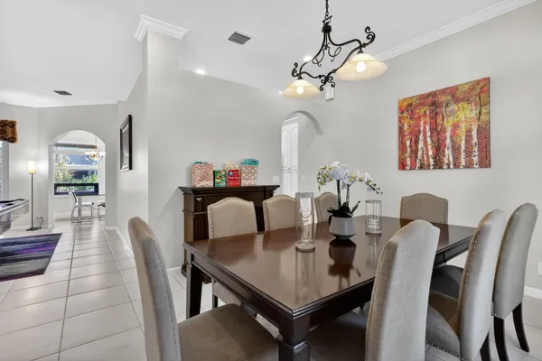 a view of a dining room with furniture and a chandelier