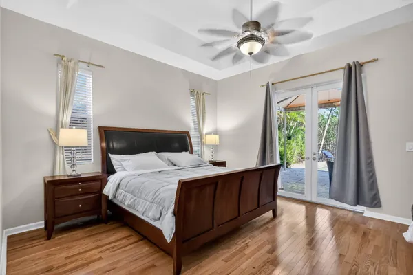 a bedroom with a bed and a chandelier