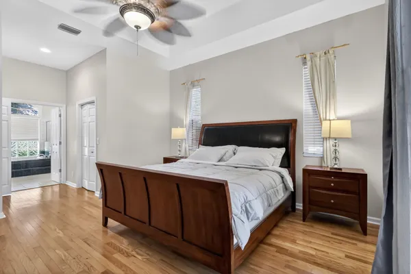 a bedroom with a bed and a chandelier