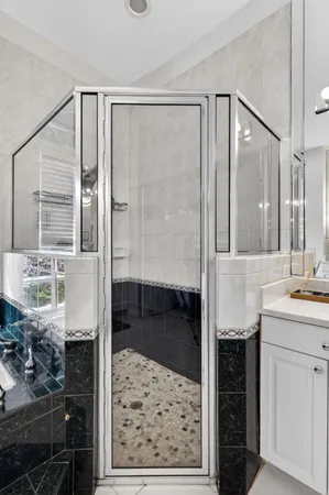 a bathroom with a double sink shower and a mirror