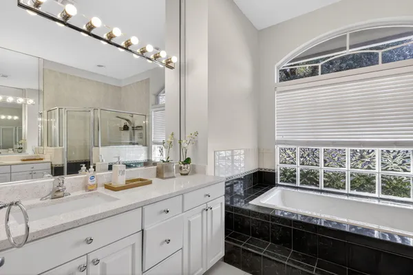 a large white kitchen with a large window