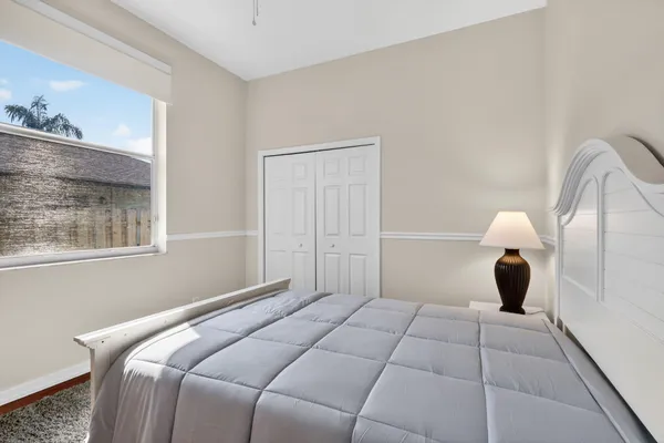 a bedroom with a bed and a lamp