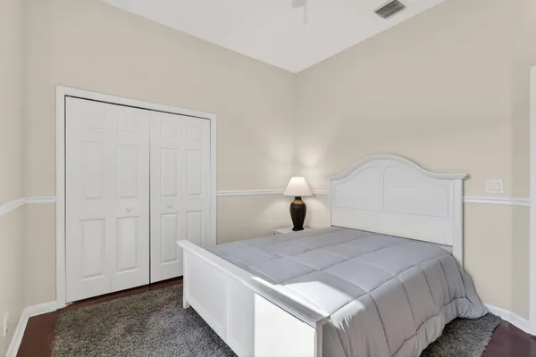 a bedroom with a bed and a lamp