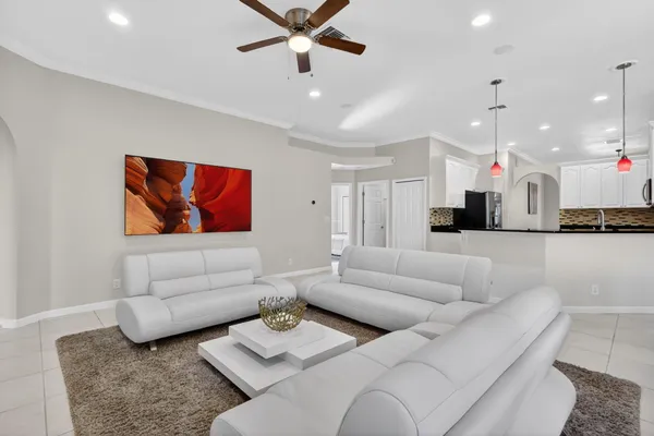 a living room with furniture cabinets and a window