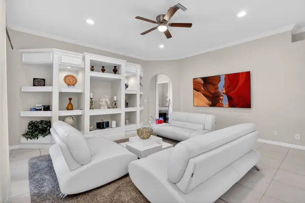 a living room with furniture potted plant and a large window