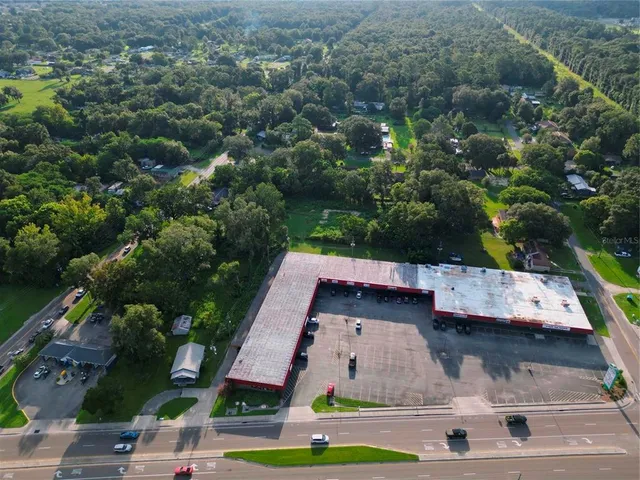 an aerial view of house with yard swimming pool and outdoor seating