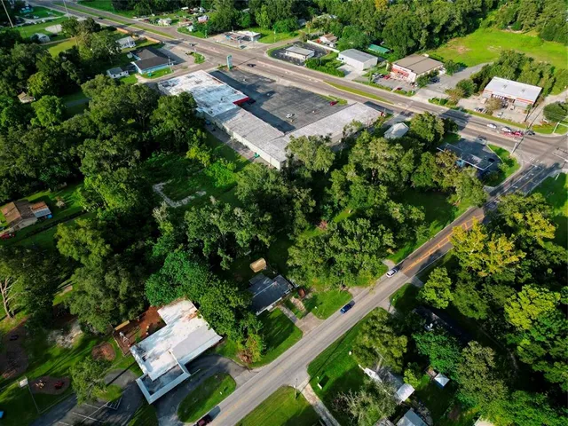 an aerial view of a residential house with a yard and plants