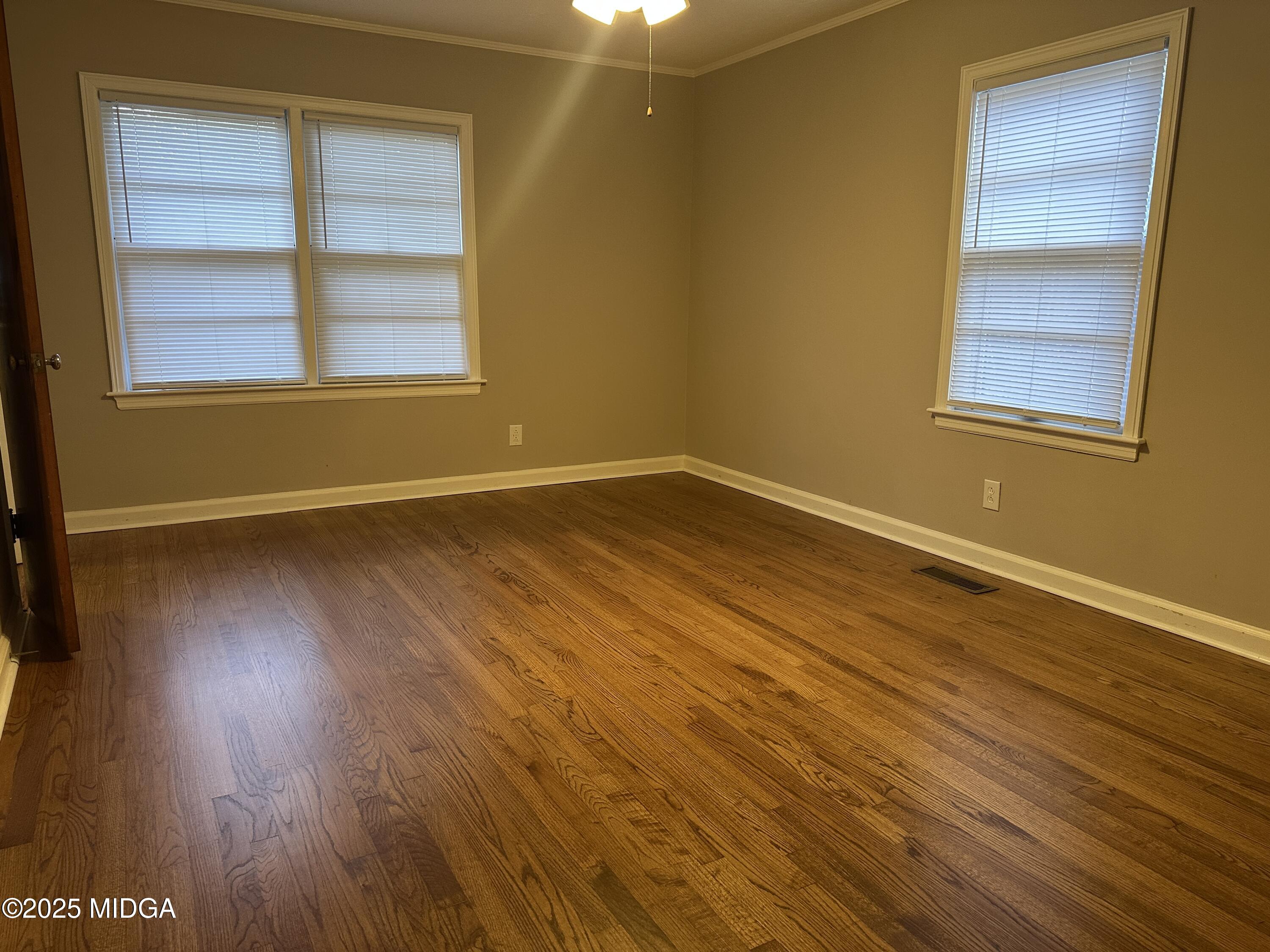 2526 Old Holton Road Macon, GA 31204 - Photo 14 of 19 an empty room with wooden floor and windows