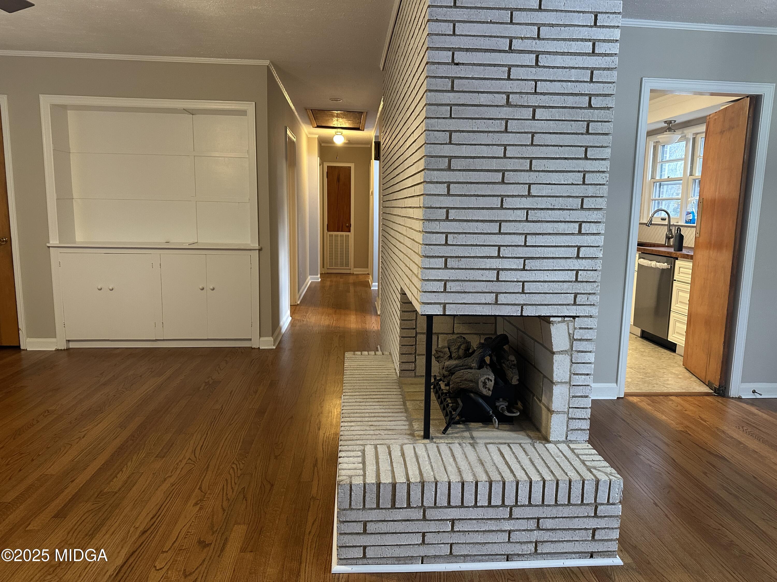 2526 Old Holton Road Macon, GA 31204 - Photo 6 of 19 a view of a bedroom with wooden floor and a fireplace
