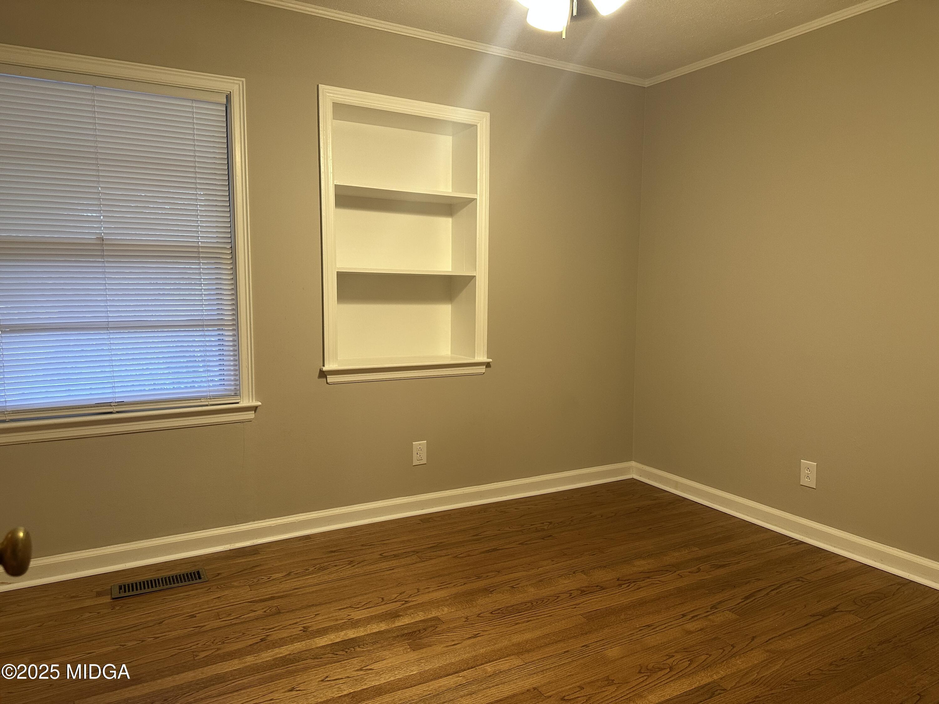 2526 Old Holton Road Macon, GA 31204 - Photo 10 of 19 a view of an empty room with wooden floor and a window