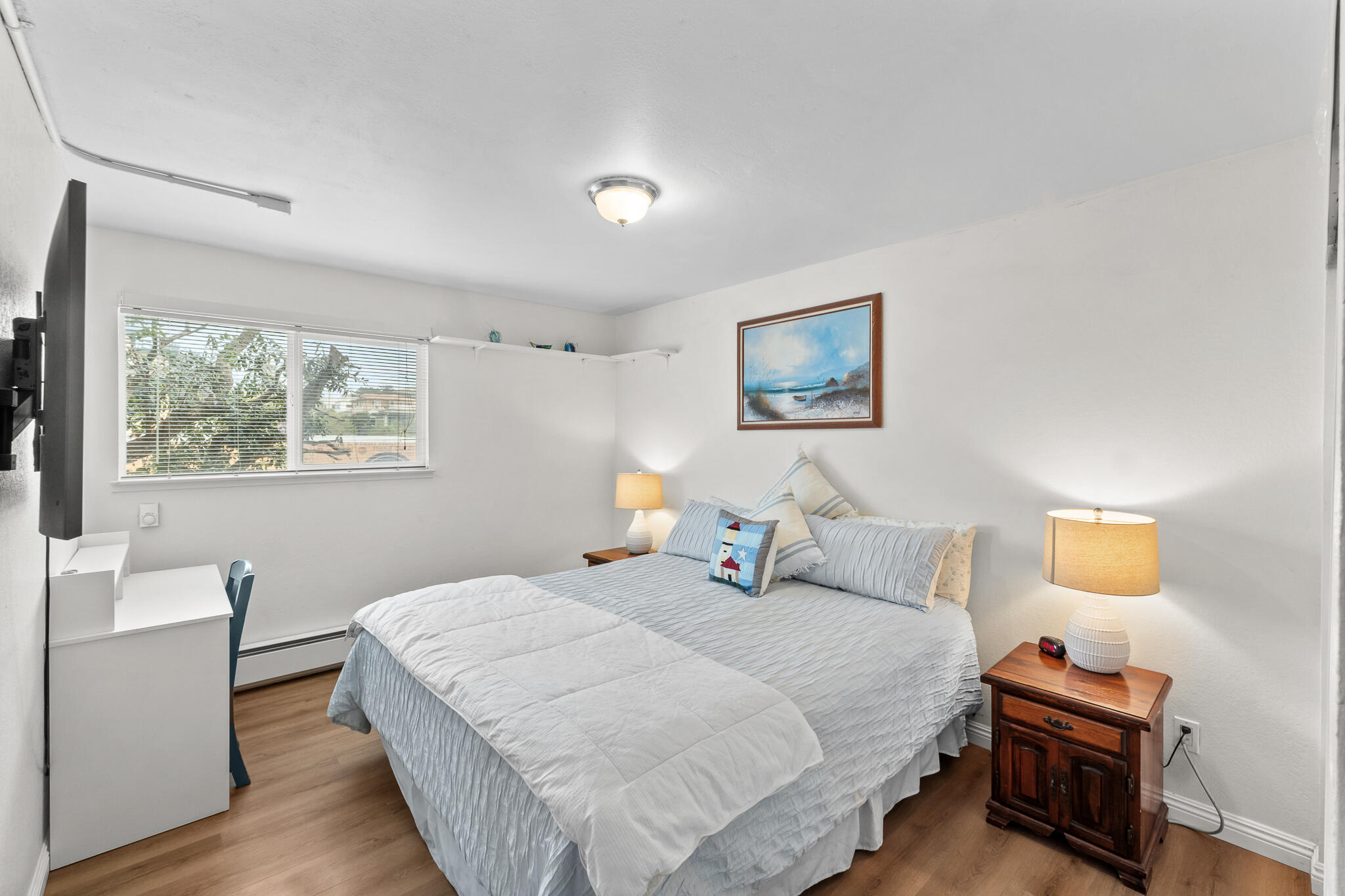 77 North Ocean Avenue, Unit 12 Cayucos, CA 93430 - Photo 25 of 41 a bedroom with a bed and wooden floor