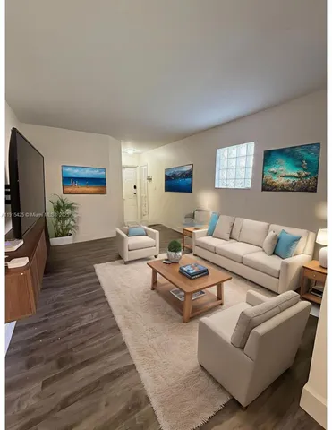 a living room with furniture a rug and a flat screen tv