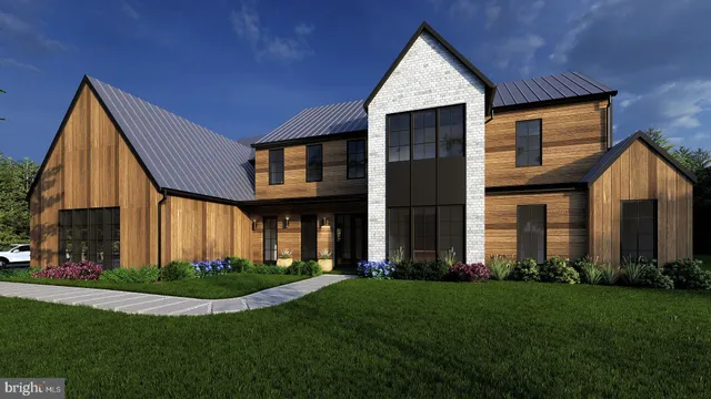 a view of a house with a yard and pathway