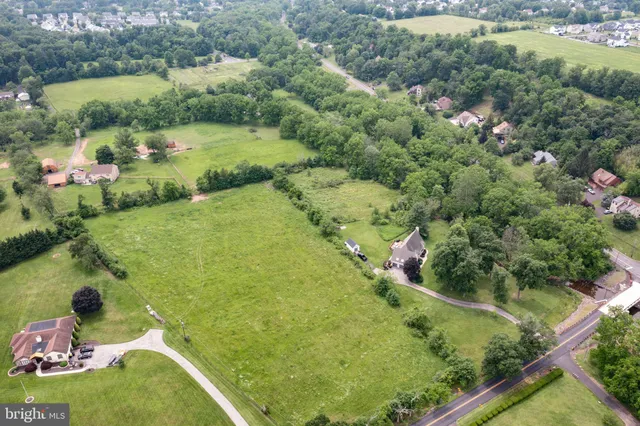 an aerial view of residential houses with outdoor space and street view