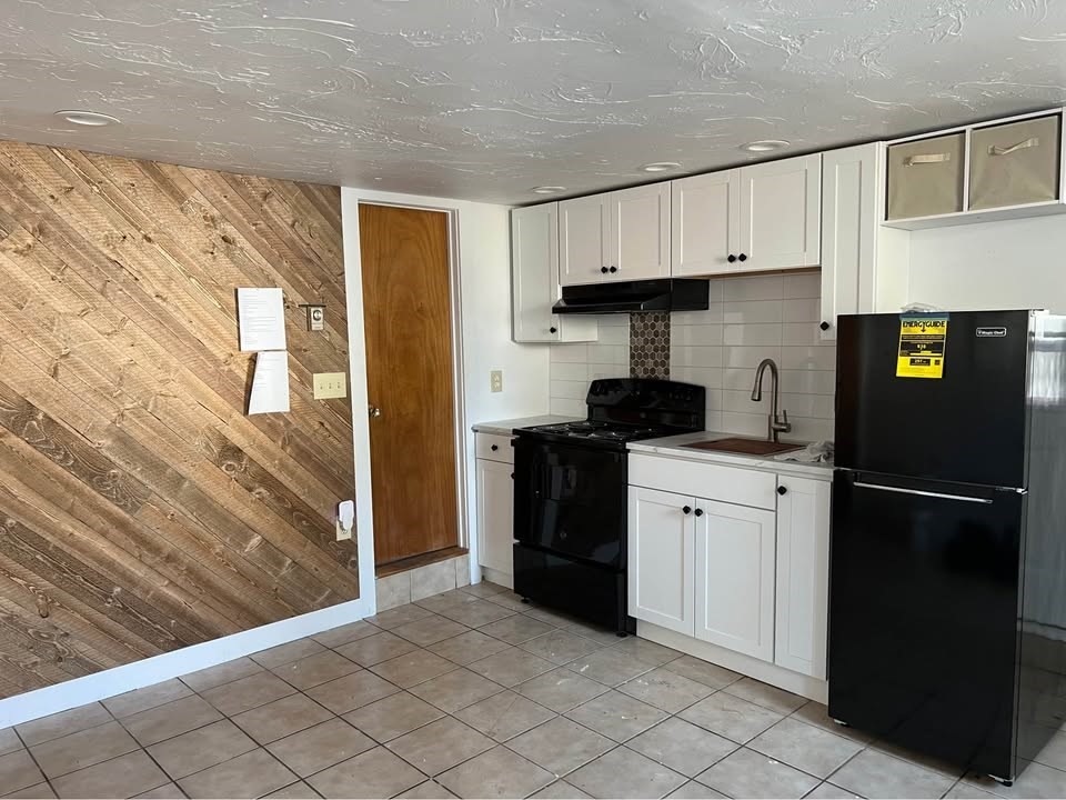 76 Lowell Street, Unit B Peabody, MA 01960 - Photo 1 of 5 a kitchen with a refrigerator and a stove