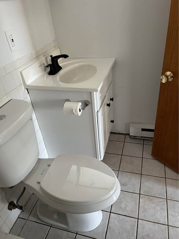 76 Lowell Street, Unit B Peabody, MA 01960 - Photo 2 of 5 a bathroom with a sink and mirror