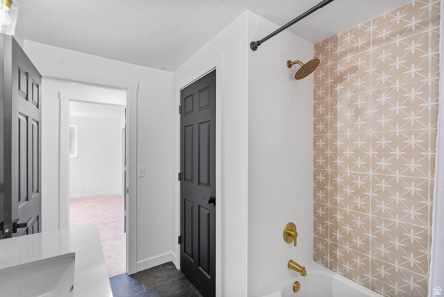 432 Calnette Drive Sandy, UT 84070 - Photo 18 of 48 Bathtub featuring a patterned tile surround and gold-tone fixtures