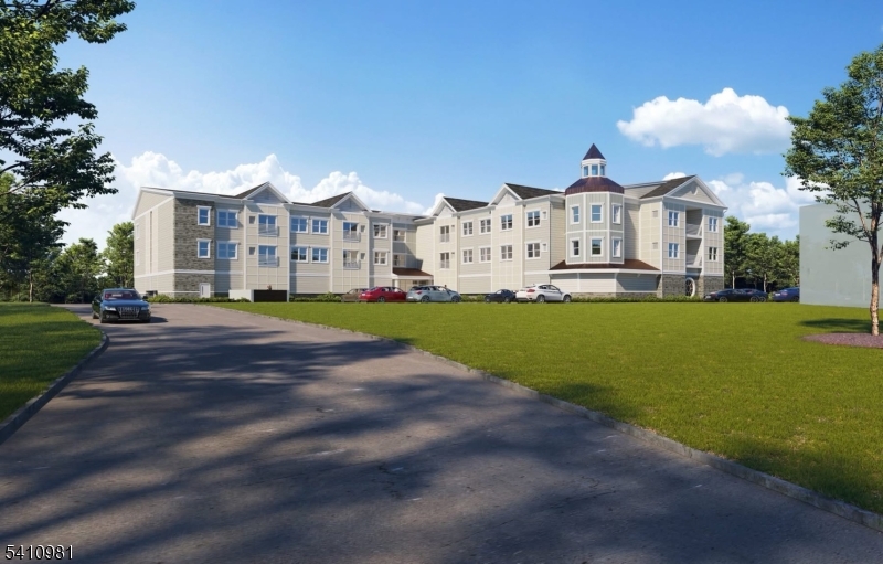 1 Main Street, Unit 2B High Bridge, NJ 08829 - Photo 2 of 2 a view of a white house with a big yard plants and large trees