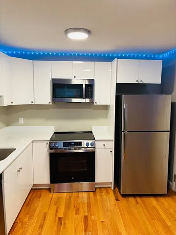 a kitchen with a refrigerator stove and a sink