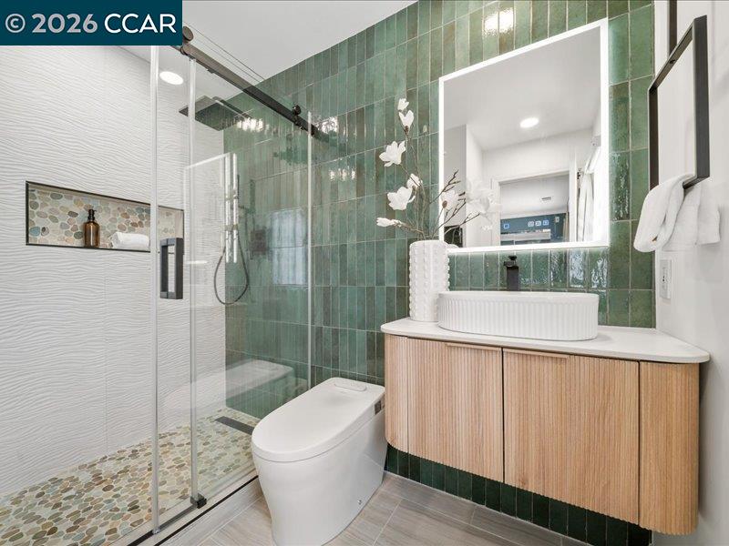 400 Fernando Court San Ramon, CA 94583 - Photo 22 of 38 a bathroom with a granite countertop sink a toilet a mirror and shower