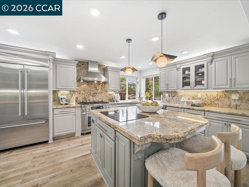 400 Fernando Court San Ramon, CA 94583 - Photo 9 of 38 a kitchen with granite countertop kitchen island stainless steel appliances a stove a sink and a refrigerator