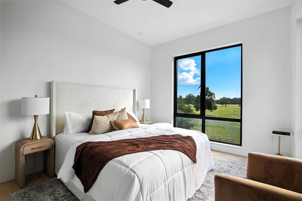 4611 Fairmount Street, Unit 102 Dallas, TX 75219 - Photo 10 of 25 a bedroom with a large bed and a window