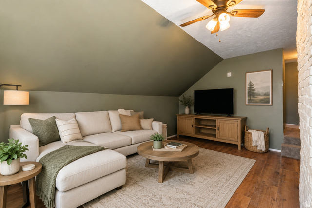 137 West 200 S Street Fairview, UT 84629 - Photo 6 of 34 Sloped ceiling room featuring wood-finish flooring, a ceiling fan, and a painted brick wall