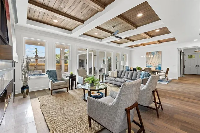 a living room with furniture and wooden floors