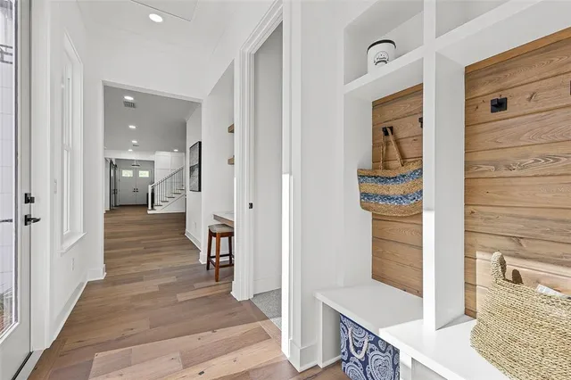 a view of a hallway with wooden floor and staircase