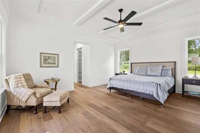 a bedroom with a bed and wooden floor