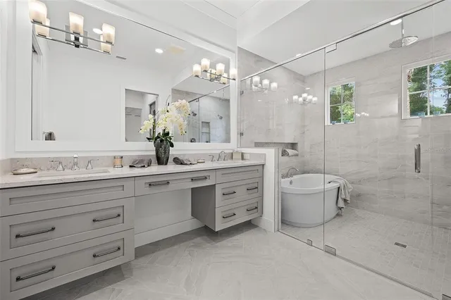 a bathroom with a double vanity sink a toilet a mirror and shower