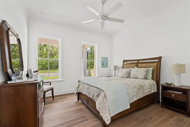 a bedroom with a bed and a large window