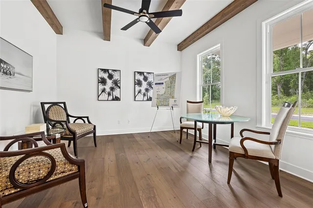 a view of a dining room with furniture window and wooden floor