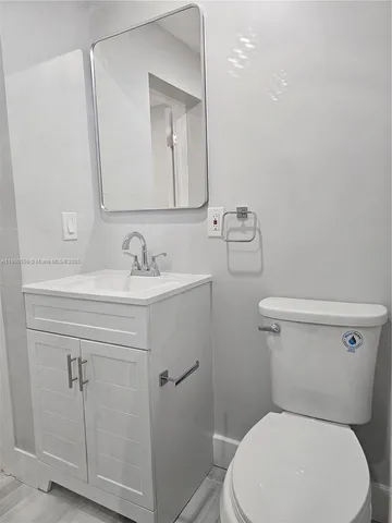 a white toilet sitting next to a bathroom sink