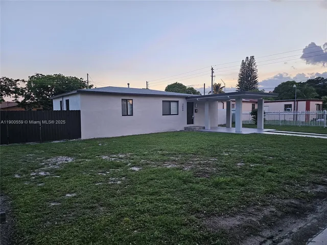 a view of a house with a yard and a garden