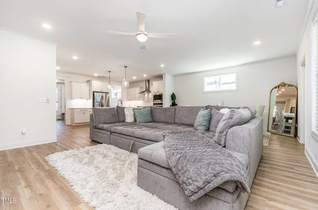 a living room with furniture and a wooden floor