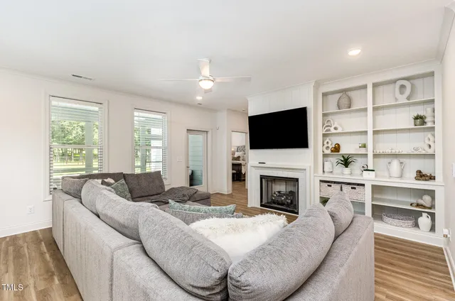 a living room with furniture fireplace and flat screen tv