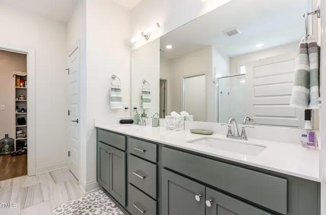a bathroom with a sink double vanity and a mirror