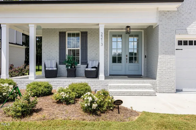 a house with potted plants in front of it