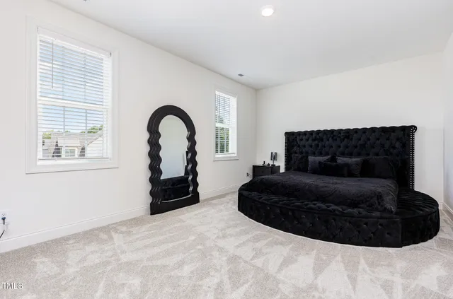 a bedroom with a bed chair and a window