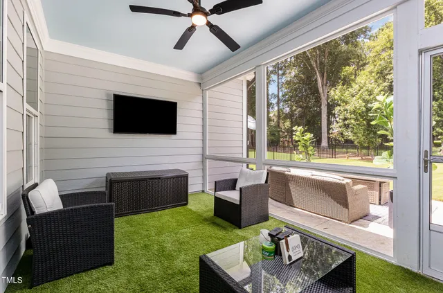 a living room with furniture a flat screen tv and a fireplace