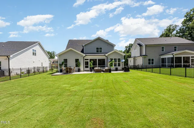 a view of house that has a big yard