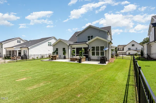 a front view of a house with swimming pool having outdoor seating
