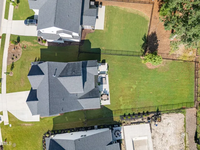 an aerial view of a houses with swimming pool